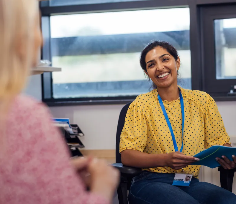 A friendly health coach supporting a client during a one-to-one healthy lifestyle session.